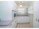 Charming kitchen with bright white cabinetry, built in oven, and tile floors for a classic look at 11945 Carmen Ave, Dade City, FL 33525