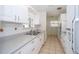 Bright kitchen featuring white cabinets, ample counter space, and stainless steel appliances at 11945 Carmen Ave, Dade City, FL 33525