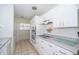 This kitchen features white cabinetry, modern appliances, and tile flooring at 11945 Carmen Ave, Dade City, FL 33525