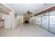 View of the fireplace and access to the kitchen and pool lanai from the living room at 11945 Carmen Ave, Dade City, FL 33525