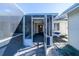 Covered and screened lanai, showing access to the home's exterior at 11945 Carmen Ave, Dade City, FL 33525
