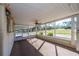 Large screened porch with carpet and views of the property at 11945 Carmen Ave, Dade City, FL 33525