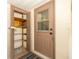Indoor access to storage shelves beside an exterior door, offering practical solutions for household items at 11945 Carmen Ave, Dade City, FL 33525