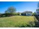 Large backyard with a grassy area and a view of the house at 12241 Perennial Pl, Bradenton, FL 34211