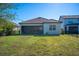 Spacious backyard with grassy lawn and view of the house at 12241 Perennial Pl, Bradenton, FL 34211
