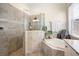 Spa-like bathroom with a large walk-in shower and a soaking tub at 12241 Perennial Pl, Bradenton, FL 34211