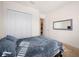 Bedroom with a queen bed, closet, and view into another room at 12241 Perennial Pl, Bradenton, FL 34211