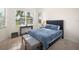 Bright bedroom with a queen-size bed and large window at 12241 Perennial Pl, Bradenton, FL 34211