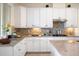 Kitchen with white cabinets, granite countertops and stainless steel appliances at 12241 Perennial Pl, Bradenton, FL 34211