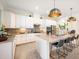 White kitchen with granite island and stainless steel appliances at 12241 Perennial Pl, Bradenton, FL 34211