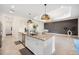Island kitchen with white cabinets, granite countertops and stainless steel appliances at 12241 Perennial Pl, Bradenton, FL 34211