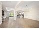 Open concept living room and kitchen with tile floors and a modern chandelier at 12241 Perennial Pl, Bradenton, FL 34211