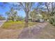 Ranch house with driveway and large tree at 15040 Lake Magdalene Blvd, Tampa, FL 33618