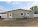 Exterior of home from backyard featuring white privacy fence, grass, and small patio at 1593 76Th N Ave, St Petersburg, FL 33702