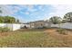 Fenced backyard with grassy lawn, white vinyl fence, and exterior view of the home at 1593 76Th N Ave, St Petersburg, FL 33702