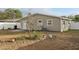 Back exterior view of the home and yard, with minimal landscaping at 1593 76Th N Ave, St Petersburg, FL 33702