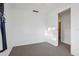 A spare bedroom with carpet and white walls leads into an open doorway at 1593 76Th N Ave, St Petersburg, FL 33702