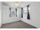 Bedroom with built in cabinets, carpeting, and blue curtains over dual windows at 1593 76Th N Ave, St Petersburg, FL 33702