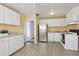 Kitchen features white cabinets, stainless steel appliances, and tile floors at 1593 76Th N Ave, St Petersburg, FL 33702