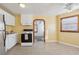 Open kitchen with white cabinets, view into adjacent living area at 1593 76Th N Ave, St Petersburg, FL 33702