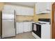 View of kitchen with stainless steel appliances and white cabinets at 1593 76Th N Ave, St Petersburg, FL 33702