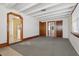 Living room with gray carpet and access to kitchen and other rooms at 1593 76Th N Ave, St Petersburg, FL 33702
