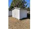 White storage shed in a backyard with a lawn and bordered by a white vinyl fence at 1593 76Th N Ave, St Petersburg, FL 33702