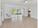 Bright living room with tile floors and sliding glass doors leading to a sunroom at 17255 2Nd E St, North Redington Beach, FL 33708