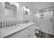 Modern bathroom with double vanity, hexagon tile, and glass shower at 2292 Austrian Ln # 34, Clearwater, FL 33763