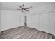 Bright bedroom with ceiling fan, ample closet space, and grey vinyl flooring at 2292 Austrian Ln # 34, Clearwater, FL 33763