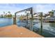 Private dock with a boat lift, perfect for convenient water access at 231 21St Ave, St Pete Beach, FL 33706