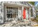 House exterior featuring a red door and large windows at 2665 Waverly Ct, Palm Harbor, FL 34684