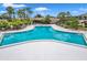 Community swimming pool with lounge area at 29130 Bay Hollow Dr # 3311, Wesley Chapel, FL 33543