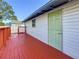 Red back deck with wooden railings, offering a peaceful outdoor space at 2918 24Th N St, St Petersburg, FL 33713