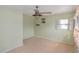 Empty bedroom with light green walls, ceiling fan, and tiled floor at 364 144Th Ave, Madeira Beach, FL 33708