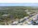 Aerial view of a house near a lush, natural area with a pond at 4148 Rudder Way, New Port Richey, FL 34652