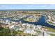 Aerial showcasing a neighborhood with canal-front houses, boats, and lush greenery at 4148 Rudder Way, New Port Richey, FL 34652