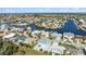 Aerial view of a waterfront house nestled in a tranquil neighborhood with canals at 4148 Rudder Way, New Port Richey, FL 34652