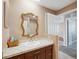 Bathroom with vanity, sink, and large decorative mirror at 4148 Rudder Way, New Port Richey, FL 34652