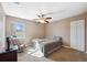 Bright bedroom with carpeted floor, a rocking chair, and large window at 4148 Rudder Way, New Port Richey, FL 34652