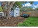 Relaxing patio furniture under large tree near shed at 4373 Trout Se Dr, St Petersburg, FL 33705