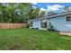 Backyard with grass, trees, and home exterior at 4373 Trout Se Dr, St Petersburg, FL 33705