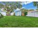 Large backyard with lush grass, a shed, and large tree at 4373 Trout Se Dr, St Petersburg, FL 33705