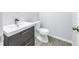 Simple bathroom with white sink, toilet, and wood-look flooring at 4373 Trout Se Dr, St Petersburg, FL 33705