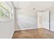Well-lit bedroom with wood-look tile floors and a window at 503 Avocado Cir, Brandon, FL 33510