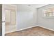 Simple bedroom with wood-look tile flooring and access to bathroom at 503 Avocado Cir, Brandon, FL 33510