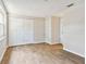 Well-lit bedroom with wood-look tile floors and white shutters at 503 Avocado Cir, Brandon, FL 33510