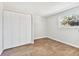 Bright bedroom with wood-look tile floors and a large closet at 503 Avocado Cir, Brandon, FL 33510