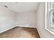 Bright bedroom featuring neutral walls and wood-look tile floors at 503 Avocado Cir, Brandon, FL 33510