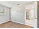 Simple bedroom with wood-look tile floors and access to another room at 503 Avocado Cir, Brandon, FL 33510